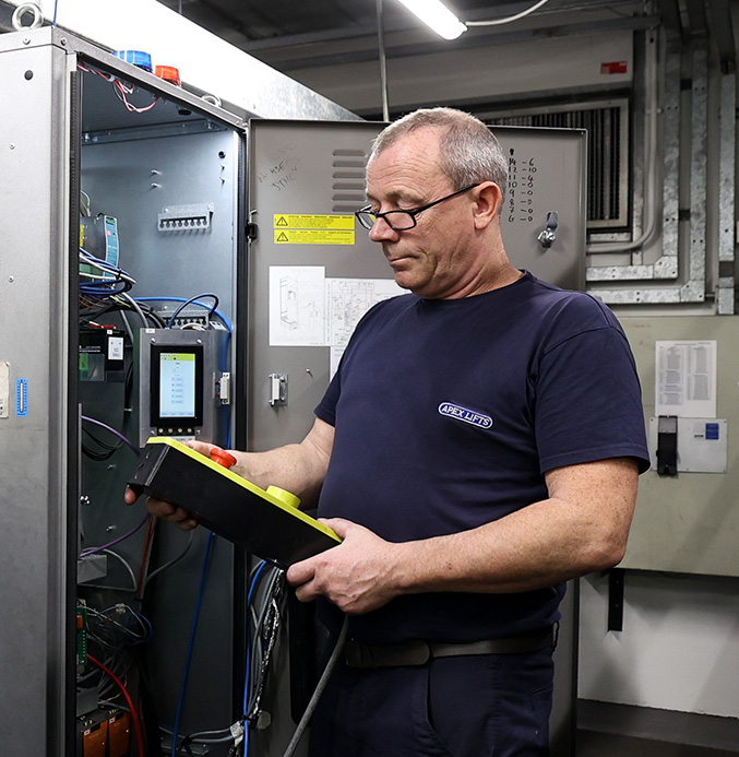 Apex engineer holding lift controller buttons